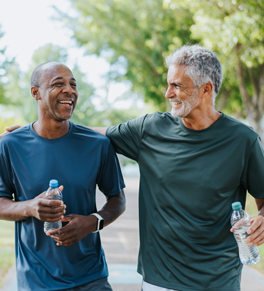 two friends walk together for healthy kidneys while hydrating with water and taking care of themselves 