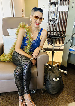 Sarah Murad is dressed in mermaid costume, sitting for her chemotherapy infusion at UCI Health Costa Mesa.