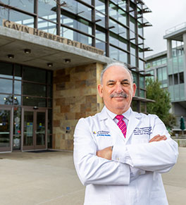 Dr. Baruch Kuppermann stands proudly in front of the Gavin Herbert Eye Institute, which he leads into its second decade of phenomenal growth.