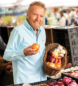 Renowned chef Pascal Olhats looks for the perfect fresh onion at a farmers' market in Orange.