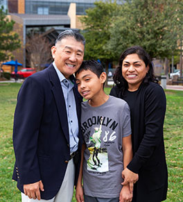 Pediatric ophthalmologist Dr. Donny Sun, at left, poses with Thiago Rojas, 13, and his mother, Sherry Sandoval, after a recent check-up post-cataract surgery.