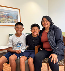 Edther Ocampo, center, returns with his brother Domenic and mother Cynthia Garcia to UCI Medical Center a year after a lighted firework exploded in his hands.