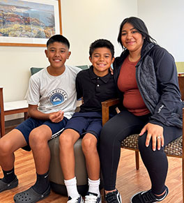 Edther Ocampo, center, returns with his brother Domenic and mother Cynthia Garcia to UCI Medical Center a year after a lighted firework exploded in his hands.