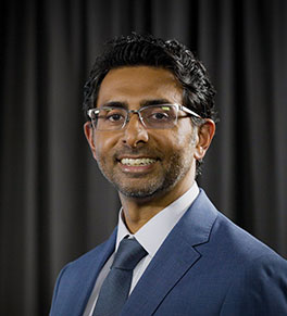Dr. Hari B. Keshava, a UCI Health thoracic surgeon and lung cancer specialist, is pictured in a blue jacket and blue tie. 