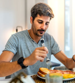 A man eats a low-residue, no-fiber diet of eggs, white bread and bacon before his colonoscopy the next day.