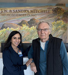 UCI Health ALS specialist Dr. Namita Goyal, left, poses with patient David Luce at a UCI Health neurology office. 