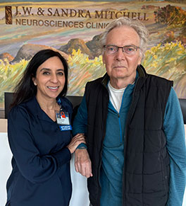 UCI Health ALS specialist Dr. Namita Goyal, left, poses with patient David Luce at a UCI Health neurology office. 