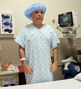 greg patterson in preop wearing a cap and hospital gown at uci health — orange