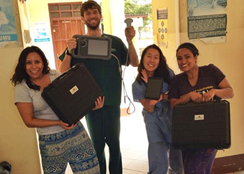 Anjali Hari, far right, carries ultrasound equipment with fellow medical students on a training mission to Tanzania in 2013.