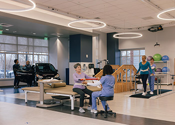 A simulation photo shows recovering patients practicing skills they will need to regain their mobility.