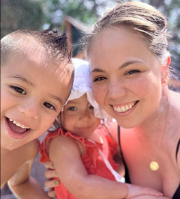 head and neck cancer survivor maliah murtha with her two young children having a pool day