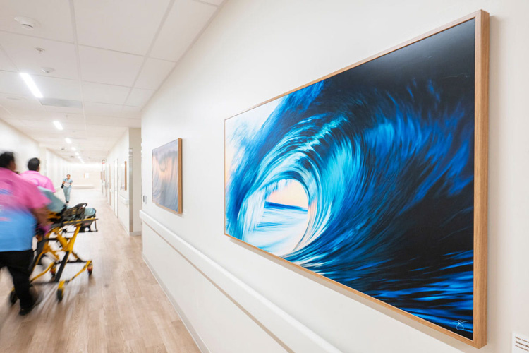 a photo called "Dream Wave,” by Beau Jesse Johnston, at UCI Health - Irvine, featuring the barrel of a large blue wave