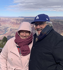 Dominick and Kathi Maggio are warmly dressed while standing in front of the Grand Canyon.