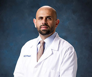 A portrait of UCI Health urologist Dr. Mohammed Shahait wearing a white clinical coat