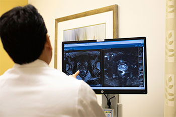 Dr. Edward Uchio examines scans from the Focal One system