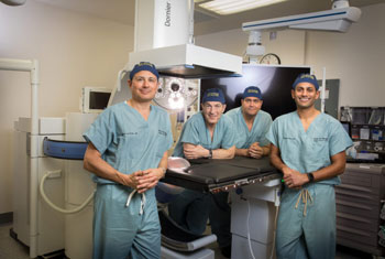 Drs. Jaime Landman, Ralph Clayman, Ramy Yaacoub and Roshan Patel (from left) show off UCI Health’s new Dornier Gemini system for the noninvasive treatment of kidney stones with shock waves.