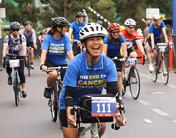 Joyous cyclists near the finish line of the 2022 UCI Anti-Cancer Challenge.