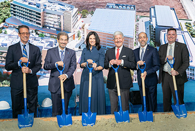 Nancy and Geoffrey Stack, center, at the 2021 UCI Health – Irvine groundbreaking, with UCI leaders, from left, Michael J. Stamos, MD, dean, UCI School of Medicine; Steven A.N. Goldstein, MD, PhD, Vice Chancellor, Health Affairs; Chad T. Lefteris, CEO, UCI Health; and Brian T. Hervey, Vice Chancellor, University Advancement and Alumni Relations. 