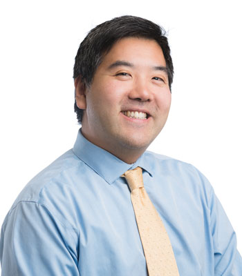 uci health physician peter chung, in front of a white background wearing blue shirt and yellow tie, is the medical director of the center for autism and neurodevelopmental disorders