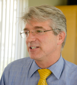 uci health psychiatrist jody rawles indoors wearing shirt tie and glasses commenting on surgeon general's warning on an epidemic of loneliness and isolation in the united states