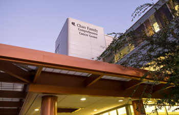 outside shot of the uci health choa family comprehensive cancer center at dusk