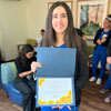 uci health nurse sarah essayli smiling and holding sunflower award