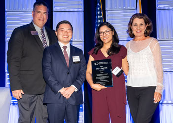attendees at the first responders dinner for uci health physician who saved lives holding awards certificate