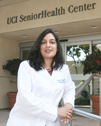 uci health geriatrician dr. sonia sehgal wearing white coat in front of the uci health senior health center in orange california