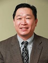 uci health orthopaedic surgeon dr yu-po lee in brown suit and dark tie with gray shirt