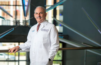 uci health ophthalmologist and chair of gavin herbert eye institute Baruch Kupperman standing near stairwell wearing white coat
