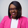 studio portrait of uci health nurse manager muriel moyo wearing a white top, pink jacket and glasses; moyo is one of the The American Organization for Nursing Leadership's nurse leaders of the year