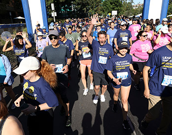 Participants in the 2023 UCI Anti-Cancer Challenge cheer as they near the finish line.