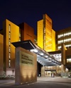 exterior of uci health medical center douglas hospital lit up in yellow at night