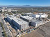 an aerial view taken by a drone of uci health irvine on a sunny day and its central utility plant, which is the first all electric plant to power a medical center