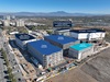an aerial view taken by a drone of uci health irvine on a sunny day and its central utility plant, which is the first all electric plant to power a medical center. the buildings are labeled with their names along their roofs.