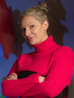 uci health dermatologist dr natasha mesinkovska wearing a black and red long-sleeve with arms crossed