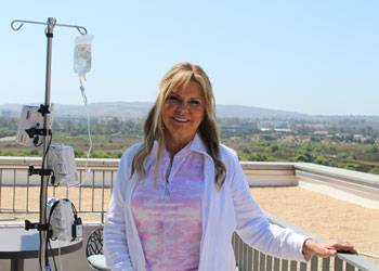 kathleen schmidt receives infusion treatment on the Nicholas R. Conway, DO, and Betty Sha Foundation Infusion Terrace at the Chao Family Comprehensive Cancer Center and Ambulatory Care building at uci health irvine
