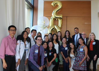 the uci health kidney transplant team gathers for a photo with baloons at a celebration of the 200th kidney transplant at UCI Medical Center