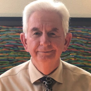 eadshot of uci health psychiatrist dr cameron carter wearing a beige shirt and tie