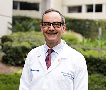 UCI Health colorectal surgeon Dr. Joseph C. Carmichael, pictured in white lab coat