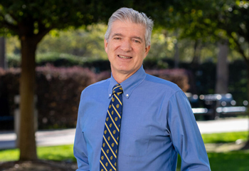 uci health psychiatrist dr jody rawles standing outside wearing a uc irvine tie and blue shirt photo courtesy of the irvine standard