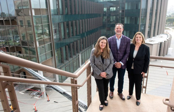 Left to right: Anne Marie Clemons-Thomas, V. Gordan Clemons Jr., M.B.A. ’04, and Marie Clemons stand in front of the Falling Leaves Foundation Medical Innovation Building, which will feature a terrace named after their family foundation. Steve Zylius / UC Irvine