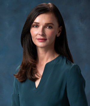 uci health chief strategy officer and senior vice president of ambulatory tatyana popkova wearing green blue in front of a blue studio background is one of becker's hospital review's CSOs to know