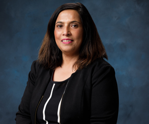 uci health chief medical information officer dr deepti pandita in front of a blue studio background