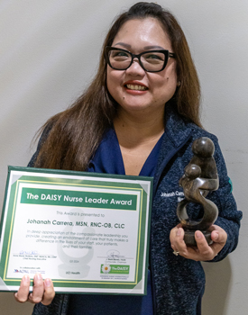 uci health nurse Johana Carrera holding her DAISY award