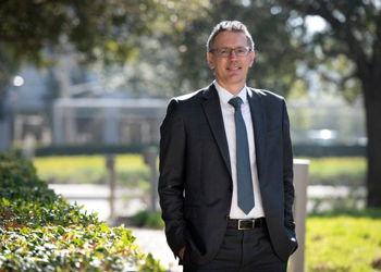 Distinguished Professor Diego Pizzagalli standing outside in a coat and tie is the founding director of the Noel Drury, M.D. Institute for Translational Depression Discoveries at UC Irvine. Steve Zylius / UC Irvine