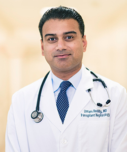 uci health transplant surgeon dr. uttam reddy wearing a white coat and stethoscope