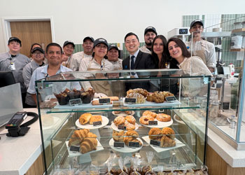 co-workers, coo nathan shinagawa and vice president hoda assadian stand behind the pastry case at the new cafe in the choa family comprehensive cancer center and ambulatory care building