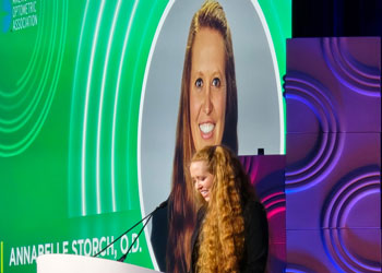 uci health optometrist annabelle storch accepts her young optometrist award on stage at the american optometry association's award ceremony