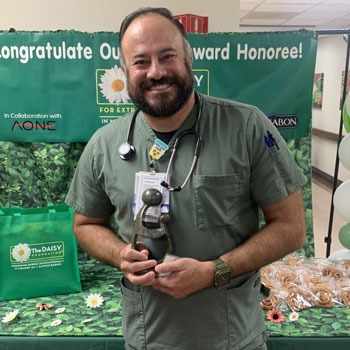 uci health los alamitos nurse max martinez holds his daisy award